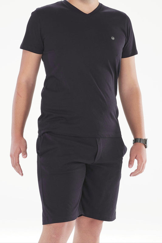 Man wearing a black t-shirt and shorts on a white background
