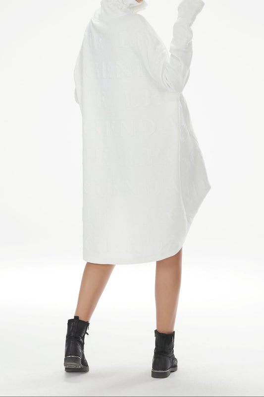 Person wearing a white turtleneck dress with long sleeves on a white background