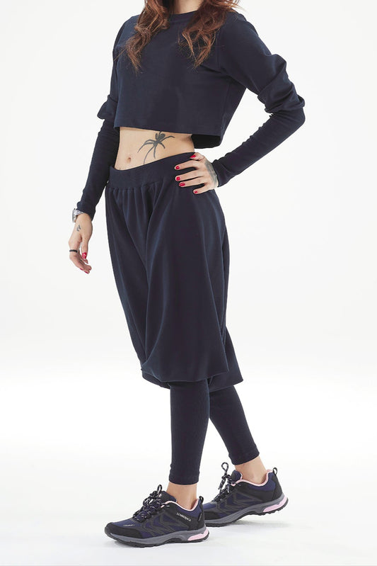 Woman wearing a black outfit with a white background