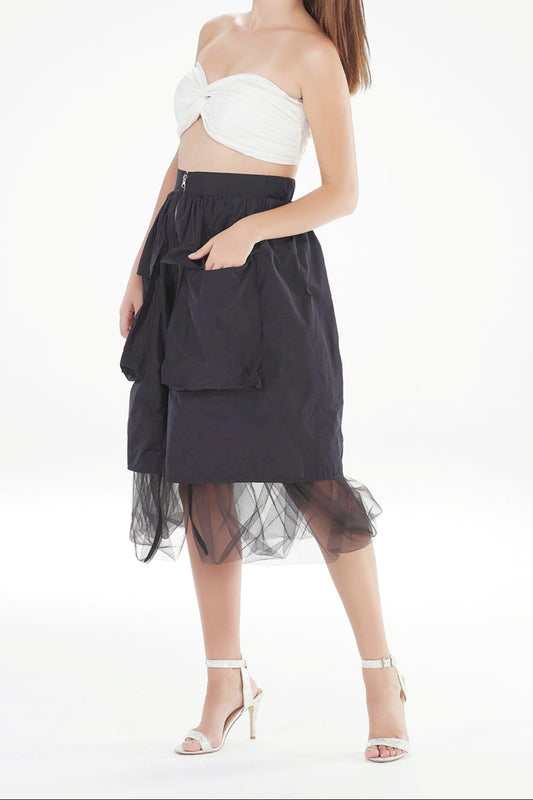 Woman wearing a white top and black skirt on a white background