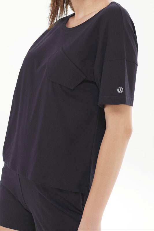 Woman wearing a black outfit with a brand logo on a white background