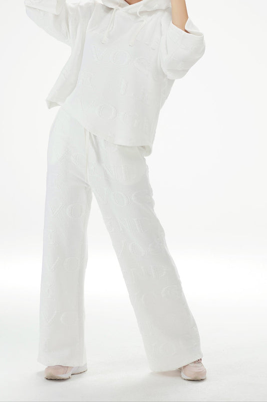 Person wearing a white hoodie and pants on a white background